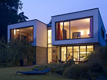 Projekt rodinného domu vychází z požadavku klienta prostory co nejvíce otevřít směrem k jezeru. Nerušený výhled zprostředkovávají úzké okenní a fasádní profily Schüco.