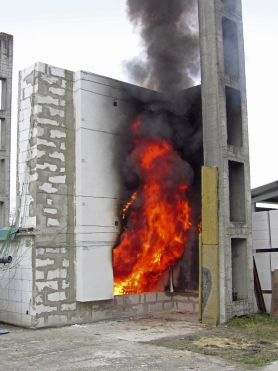 Obr. 9, 10: Výška plamene při testu s výkonem 3 MW dosahuje přímo do úrovně oken následujícího podlaží. V případě použití běžných dřevěných nebo plastových oken velmi pravděpodobně při tomto výkonu požáru dojde k jejich poškození a rozšíření požáru „z okna do okna“.