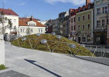 Parkovací část objektu se navenek projevuje pouze částečně prosklenou kupolí nad vstupním prostorem, osázenou rozchodníky (s automatickým zavlažovacím systémem), obousměrnou vjezdovou rampou a prosklenou stěnou do vstupního prostoru