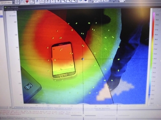 Demonstrace fungování akustické kamery. Zelené body na obrazovce zachycují umístění mikrofonů. Intenzita barvy rozlišuje sílu akustické energie. Zde červená ukazuje místo s nejsilnějším zdrojem hluku.