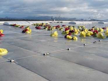 Provizorní přitížení havarované části střechy pytli s pískem