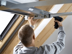 Ocelový rám opláštění. Po osazení rámu okna následuje montáž sádrokartonového ostění. Pro jednodušší montáž je vhodné použít montážní soupravu pro sádrokartonové ostění. Nejprve se upevní ocelový rám, který je základem pro vytvarování samotného sádrokartonového obložení. Montáž urychlují teleskopické profily.