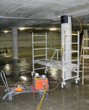 Obr. 3: Provádění radiografie vrcholové partie sloupu v 1. PP; dobře patrný kryt se zářičem Co60, žlutá výsuvná hadice pro zářič a radiografický film na bočním líci sloupu