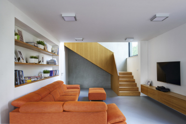 Na podlahách je litá polyuretanová stěrka, u schodiště propojujícího obě části stavby autor použil šedou broušenou fasádu, která je i v exteriéru masivní stavby