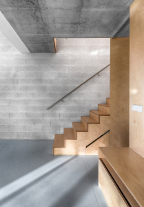 Hladký povrch podlah a nábytku v kontrastu s režným zdivem