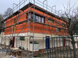 Ochrana zateplené fasády s obkladem s otevřenými spárami. Fotografie ze stavby v rozpracovaném stavu - barva jantarově oranžová (zdroj: Dörken)