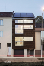 Dřevostavba stojí na betonové podnoži, její průčelí je bohatě prosklené